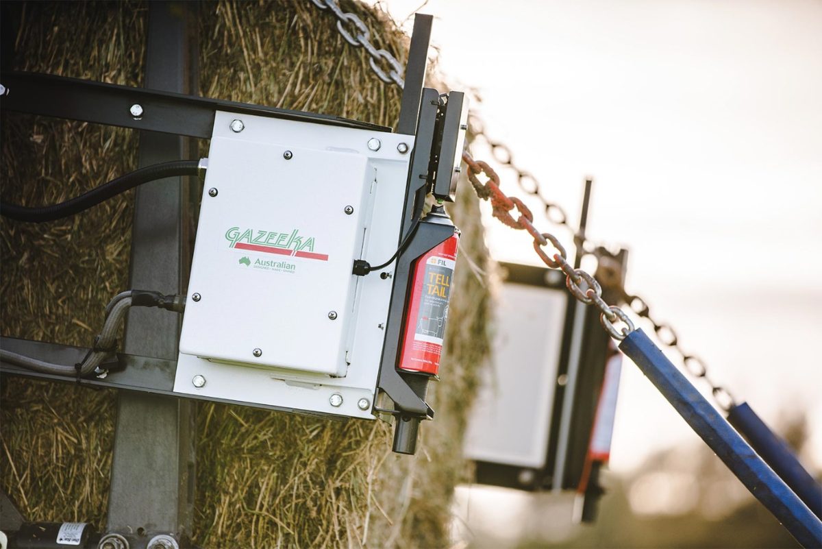 Big square baler working an Iowa field, fitted with replacement parts from The Fine Twine Co.