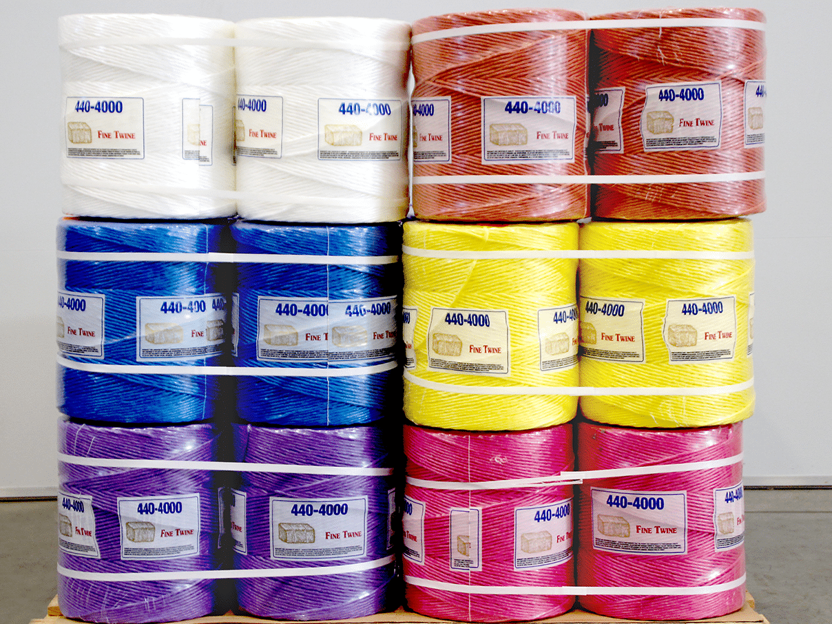 Pallet of Fine Twine 440-4000 baler twine spools in white, red, blue, yellow, purple, and pink
